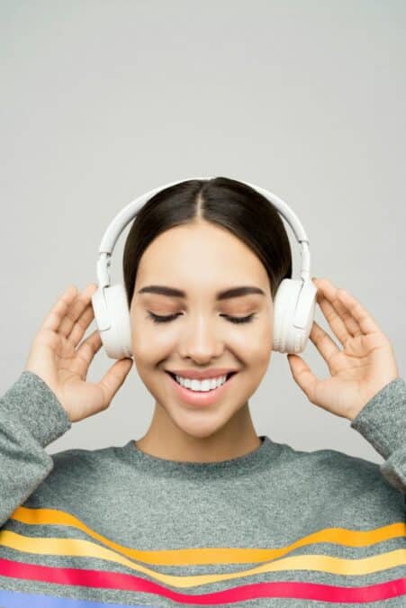 Best Noise-Cancelling Headphones for Remote Work in 2025 A professional woman working from home wearing the best noise-cancelling headphones for remote work, focusing on a Zoom call at her home office desk.